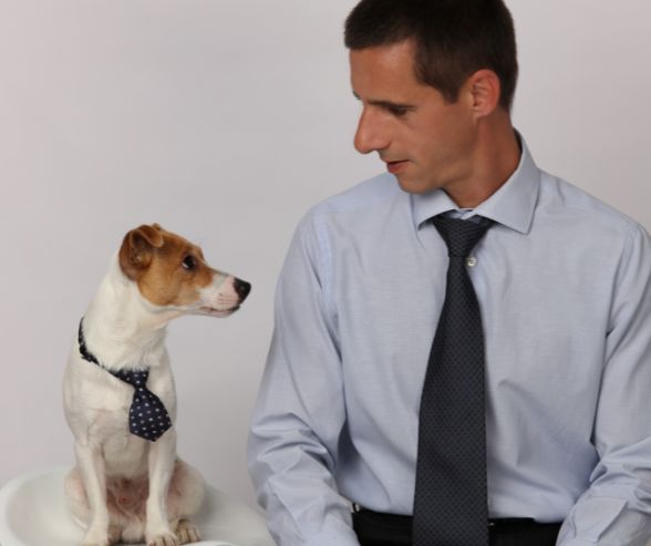 Dog and owner Halloween costumes featuring a man and his dog both dressed in business attire with matching ties.